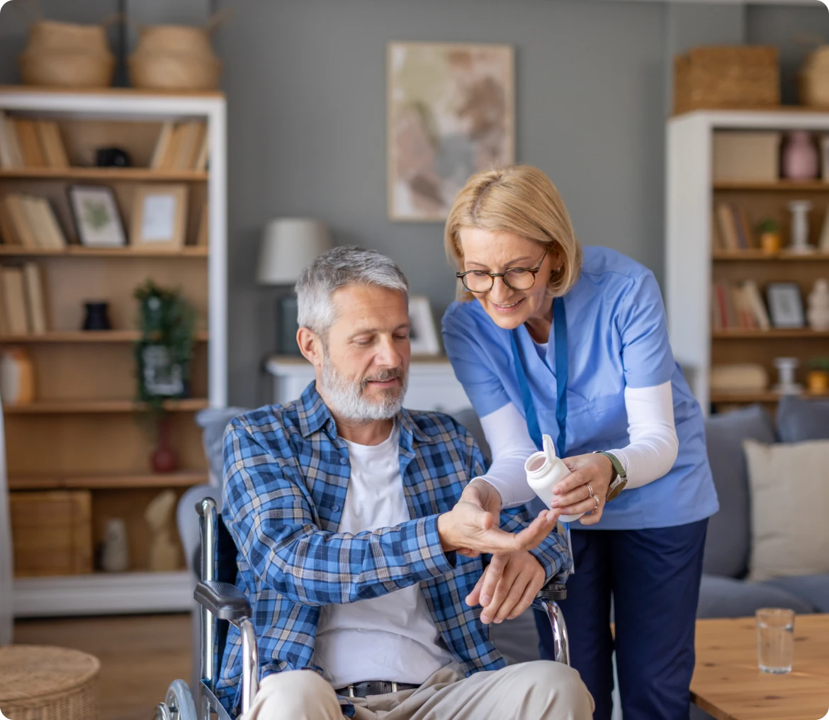 Caregiver assisting man in wheelchair